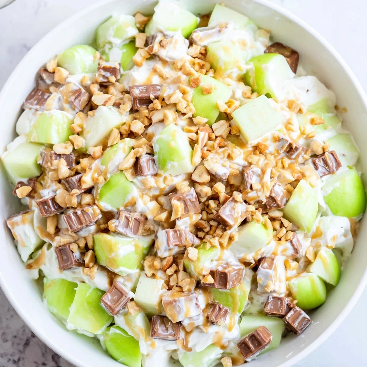 Bright, refreshing bowl of Snickers Salad: creamy and chunky, perfect for a summer dessert.
