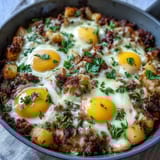 Corned beef hash breakfast skillet with eggs, crispy potatoes, sautéed vegetables, and perfectly cooked eggs in a savory skillet meal.