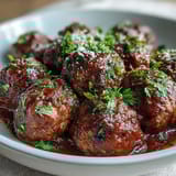 A hearty batch of slow cooker meatballs in rich tomato sauce, perfect for feeding a crowd at your next gathering.  