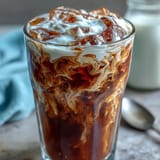 Smooth cold brew coffee with creamy vanilla sweet cream, a delightful chilled beverage.