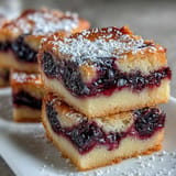 Bright, tangy blackberry lemon bars swirled atop buttery shortbread, a delightful treat.