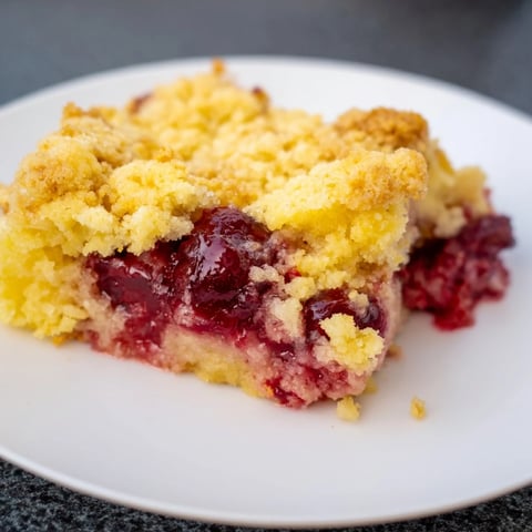 Golden brown Dump Cake bubbling after baking, ready for a scoop of vanilla ice cream.