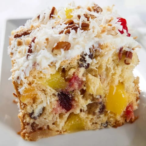 The finished fruit cocktail cake: a golden-brown masterpiece, generously frosted, ready to serve and enjoy.