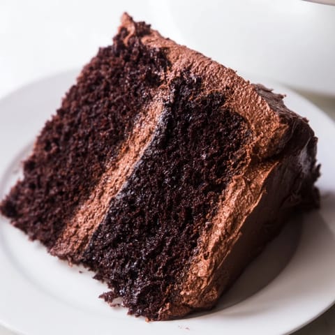Delectable layers of moist Devil's Food Cake, a classic American dessert, perfect for celebrating.