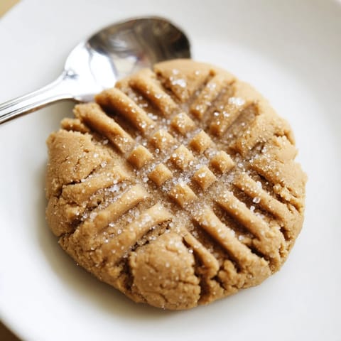 Freshly baked peanut butter cookies, soft and chewy, offering a delightful peanut butter taste.