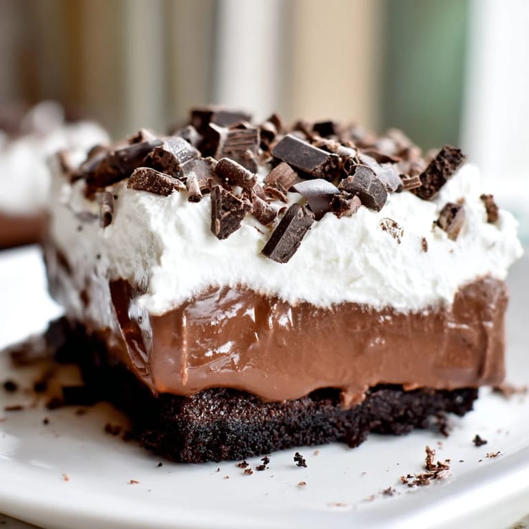 This homemade Mississippi Mud Pie features a brownie base, creamy pudding, and whipped cream topping.