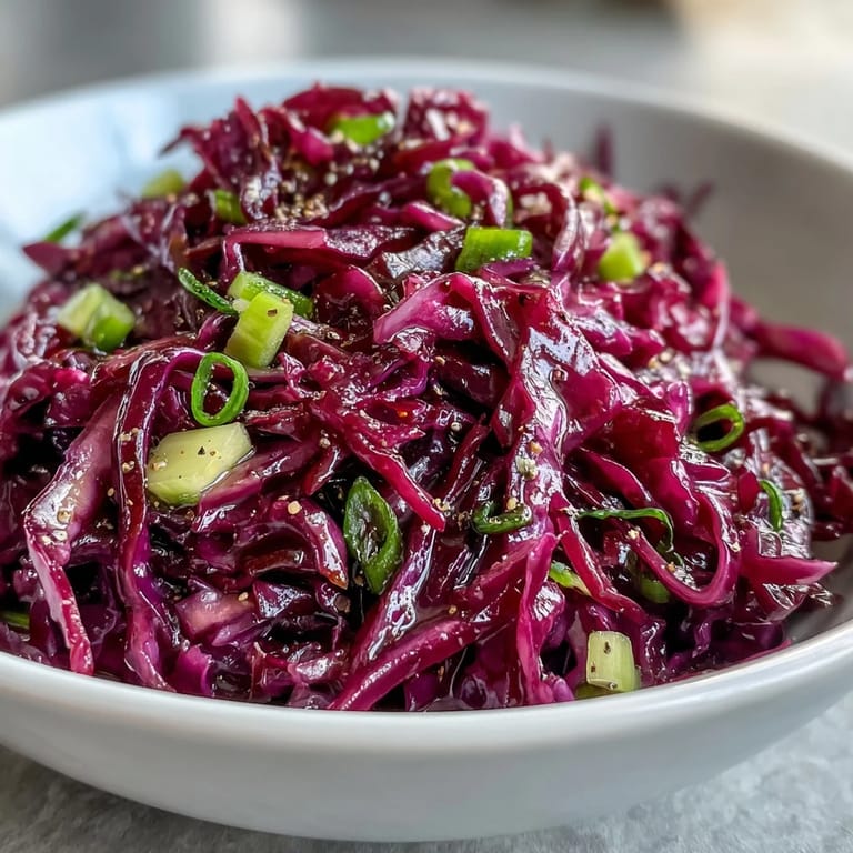 Tangy apple cider vinaigrette coats colorful ribbons of red cabbage, sweet apple, and savory Parmesan in this easy Red Cabbage Coleslaw With Apple and Parmesan.