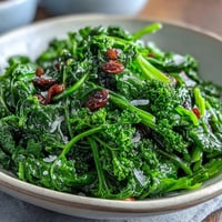 Fresh arugula salad with tangy lemon vinaigrette and delicate Parmesan shavings, a vibrant and healthy side dish.  